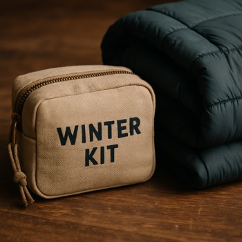 Small pouch labeled winter kit placed next to a folded jacket
