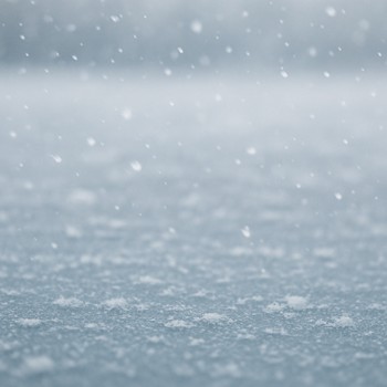 Light snow flurries crossing a frozen lake surface